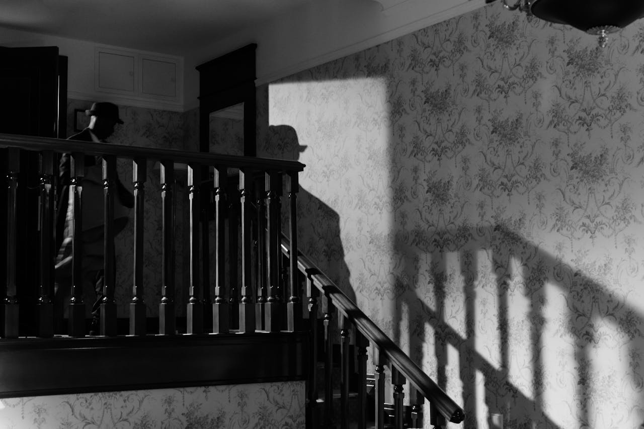 about-01 A mysterious noir scene with a detectives shadow on a vintage staircase.